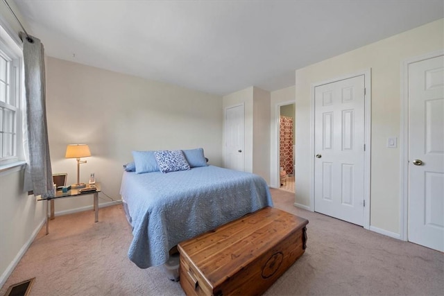 bedroom featuring light colored carpet