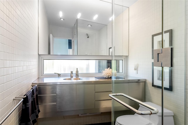 bathroom featuring vanity and tile walls