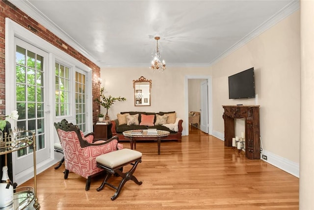 living room featuring wood-type flooring, crown molding, brick wall, and a chandelier