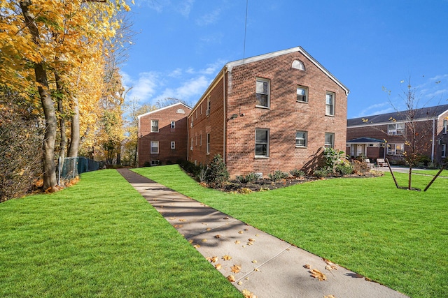 view of side of home featuring a yard