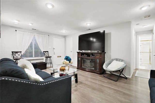 living room with a wealth of natural light and light wood-type flooring