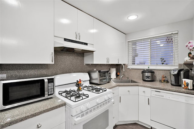 kitchen featuring white cabinetry, sink, white appliances, and decorative backsplash