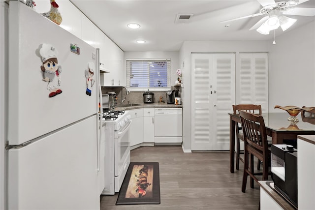 kitchen with sink, white cabinets, hardwood / wood-style flooring, ceiling fan, and white appliances