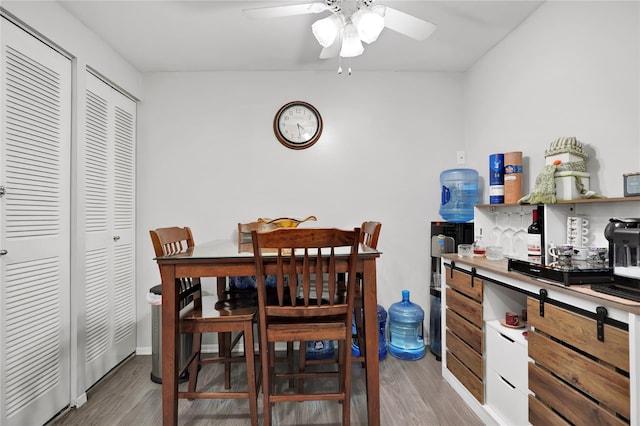 dining room with ceiling fan and light wood-type flooring