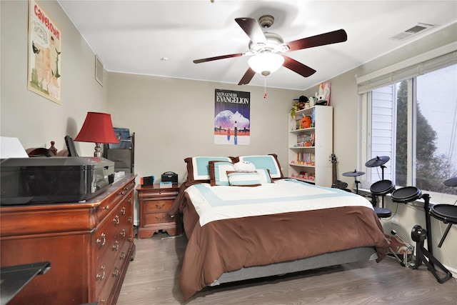 bedroom with wood-type flooring and ceiling fan