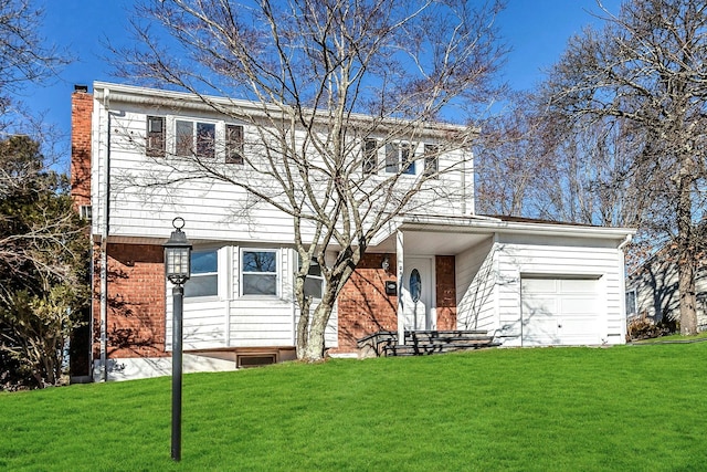 view of front of house featuring a front yard and a garage