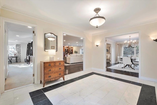 hall with ornamental molding and a notable chandelier