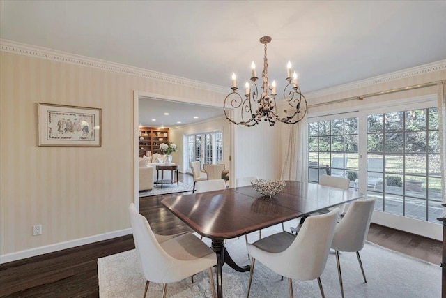 dining space with dark wood-type flooring, crown molding, and an inviting chandelier