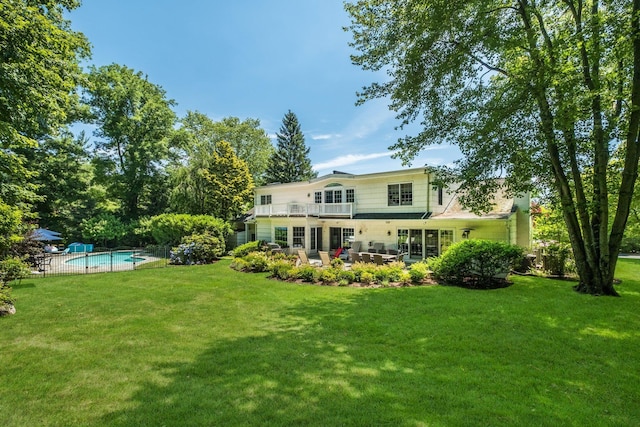 rear view of property featuring a patio and a lawn