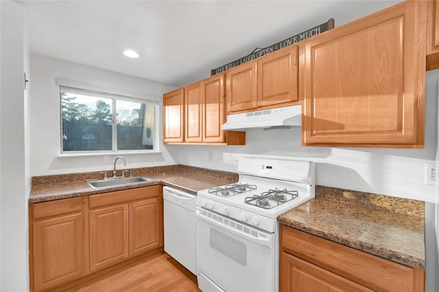 kitchen featuring white appliances, sink, and light hardwood / wood-style flooring