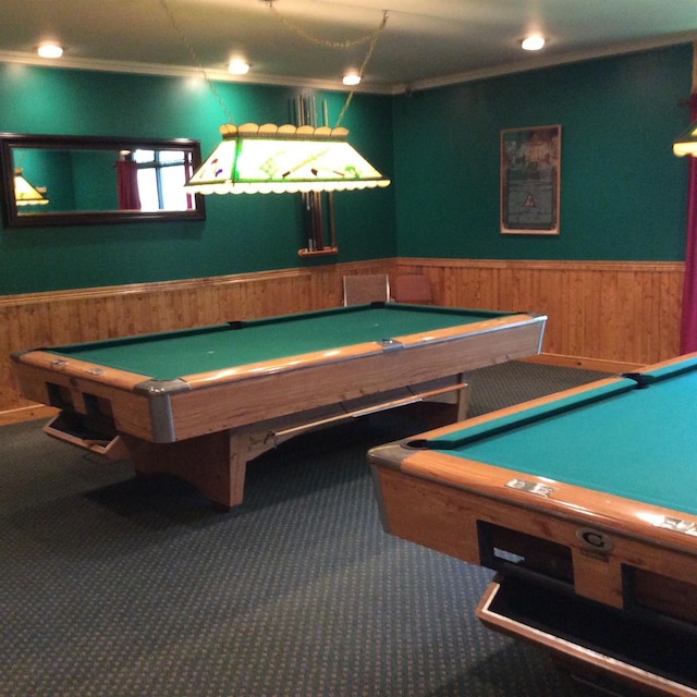 recreation room with pool table, wooden walls, and dark carpet