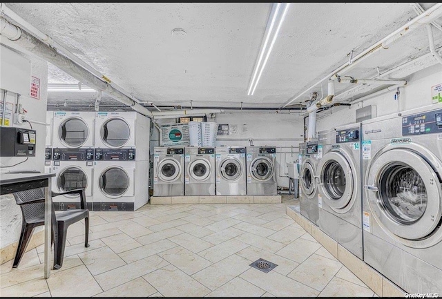 laundry area with washing machine and dryer, stacked washing maching and dryer, and a textured ceiling