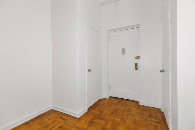 hallway featuring dark parquet flooring