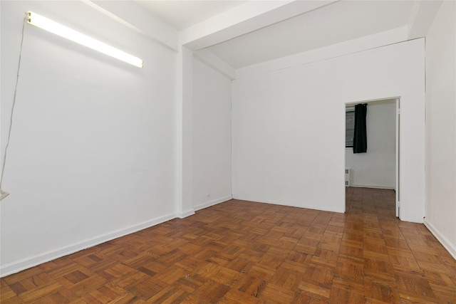 unfurnished room featuring dark parquet flooring