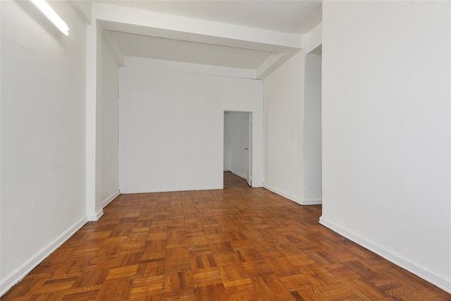 unfurnished room featuring dark parquet flooring