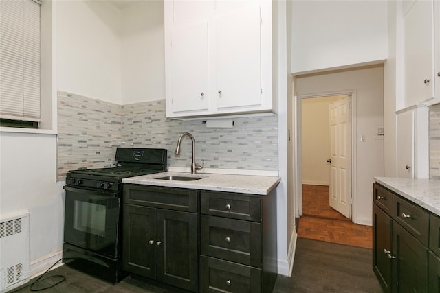 kitchen with backsplash, dark hardwood / wood-style floors, black range with gas stovetop, light stone counters, and sink