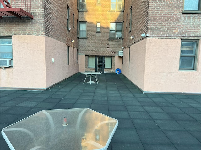 view of pool with cooling unit and a wall mounted air conditioner