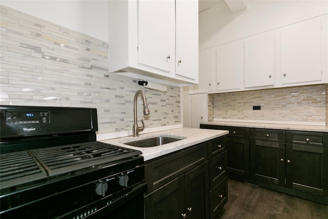 kitchen with tasteful backsplash, sink, white cabinetry, and black range with gas cooktop