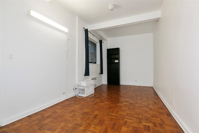 spare room with dark parquet floors