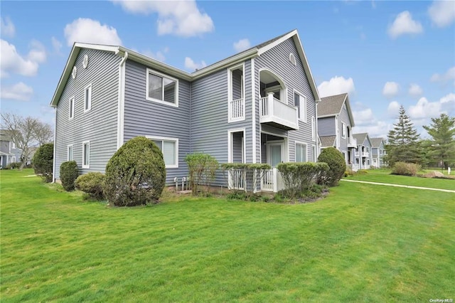 exterior space with a balcony and a yard