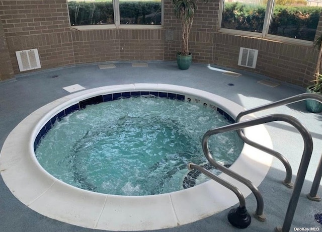 view of swimming pool featuring an in ground hot tub