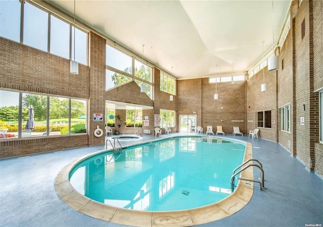 community pool with a patio area and an indoor in ground hot tub