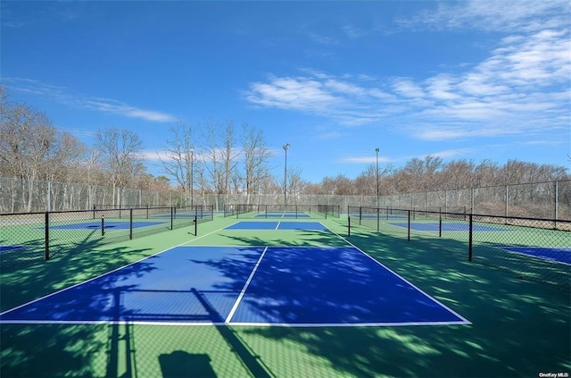 view of sport court featuring fence