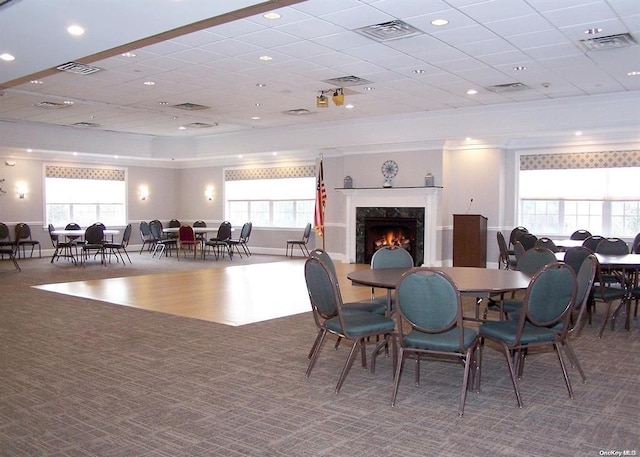 dining area with carpet, a premium fireplace, and visible vents