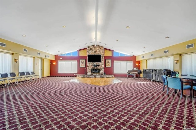 misc room with vaulted ceiling, carpet floors, a fireplace, and visible vents