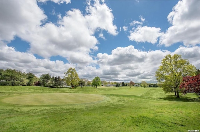 view of home's community featuring a yard and golf course view