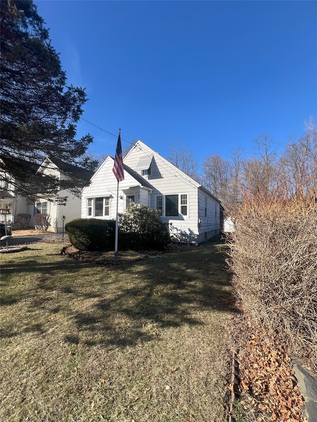 view of side of home with a yard