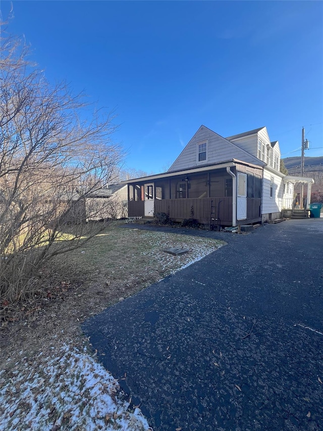 view of side of home with a sunroom