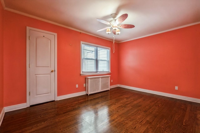 unfurnished room with crown molding, dark hardwood / wood-style flooring, and radiator