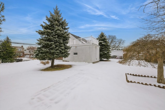 yard layered in snow featuring a balcony