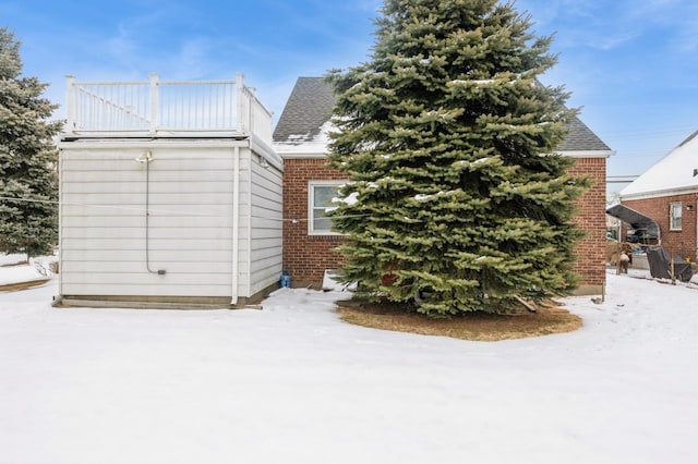 snow covered property with a balcony