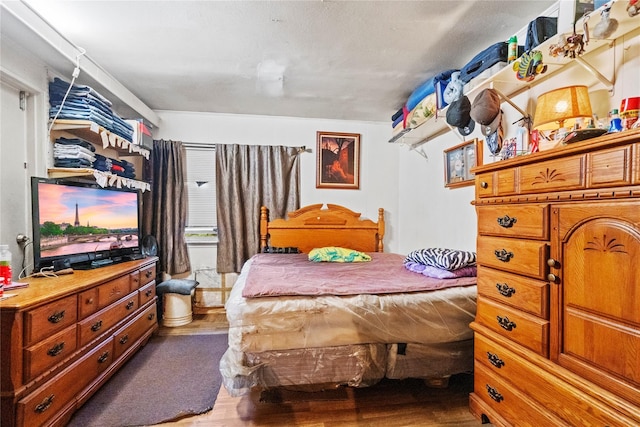 bedroom with hardwood / wood-style floors