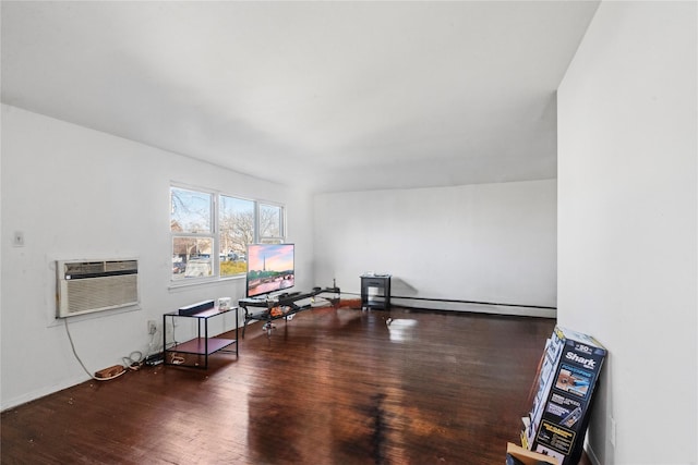 interior space featuring dark wood-type flooring, a wall unit AC, and a baseboard radiator