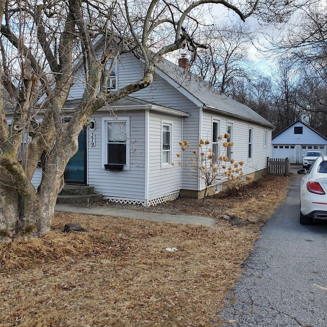 view of side of property featuring a garage and an outdoor structure