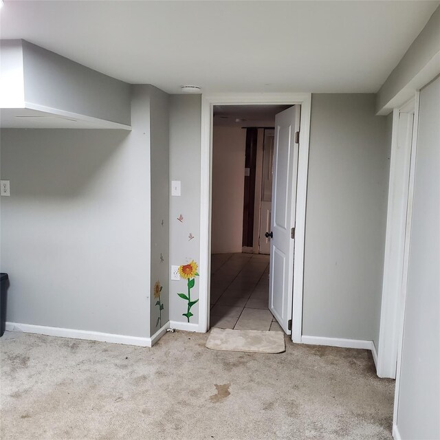 unfurnished room featuring light carpet