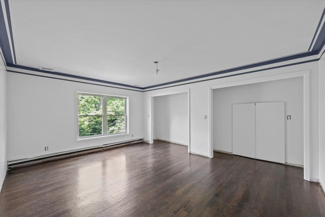 unfurnished bedroom featuring dark hardwood / wood-style flooring, crown molding, and a baseboard heating unit