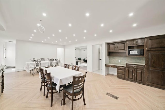 dining room featuring light parquet floors