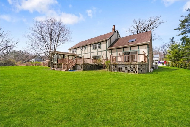 back of property featuring a deck and a yard