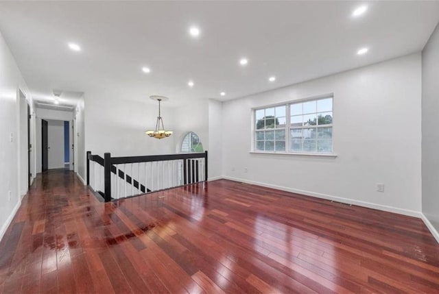 empty room with dark hardwood / wood-style floors