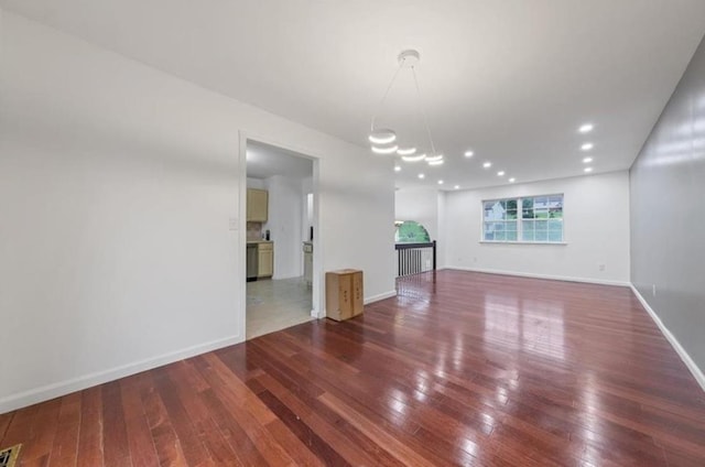 unfurnished room with wood-type flooring