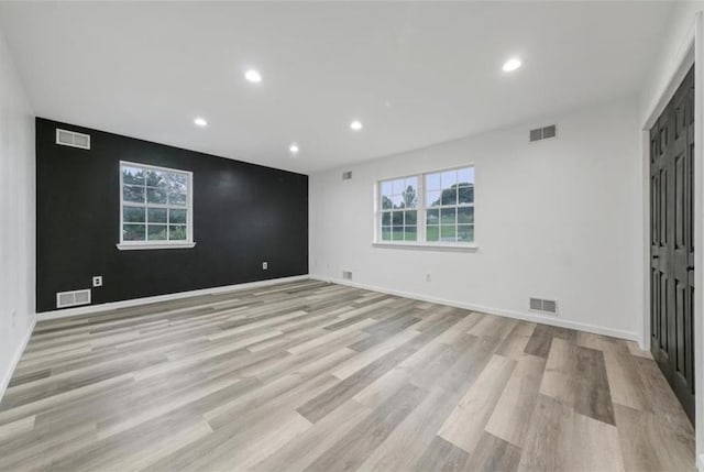 empty room with light hardwood / wood-style floors