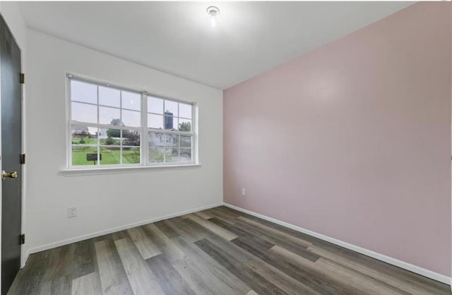 unfurnished room featuring dark wood-type flooring