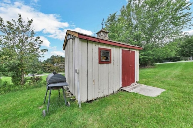 view of outbuilding with a yard