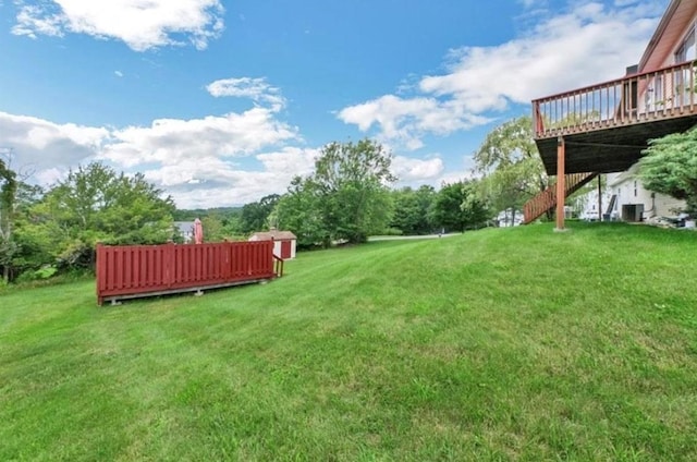 view of yard featuring a wooden deck and central air condition unit