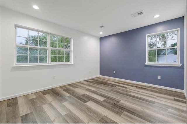 spare room with light hardwood / wood-style floors