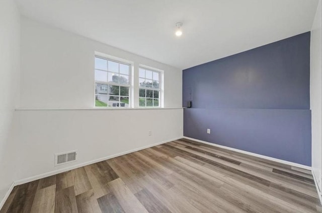 empty room featuring hardwood / wood-style flooring